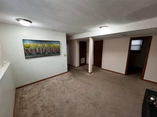 basement with light colored carpet and a textured ceiling