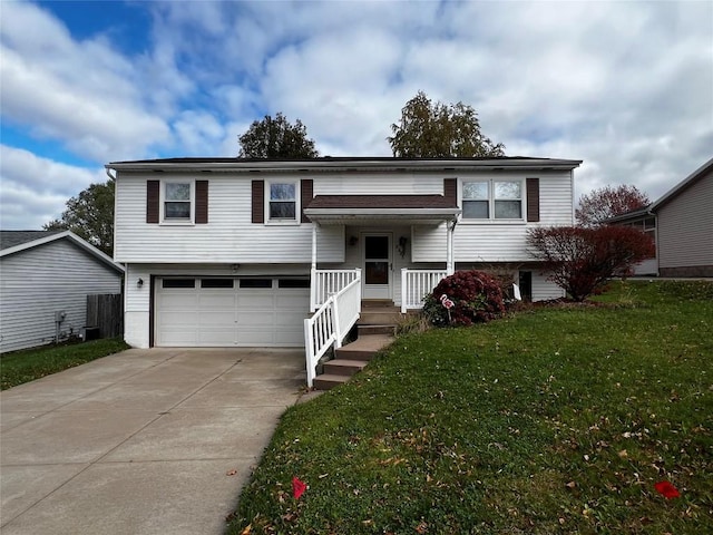 split foyer home with a front lawn and a garage