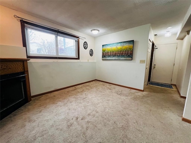 carpeted spare room with a textured ceiling