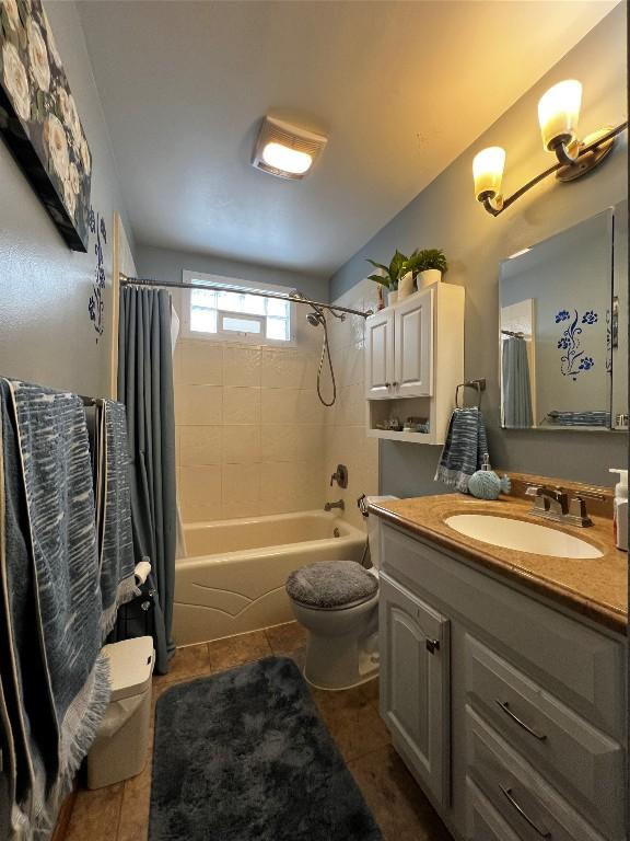 full bathroom featuring tile patterned floors, shower / bath combo, toilet, and vanity