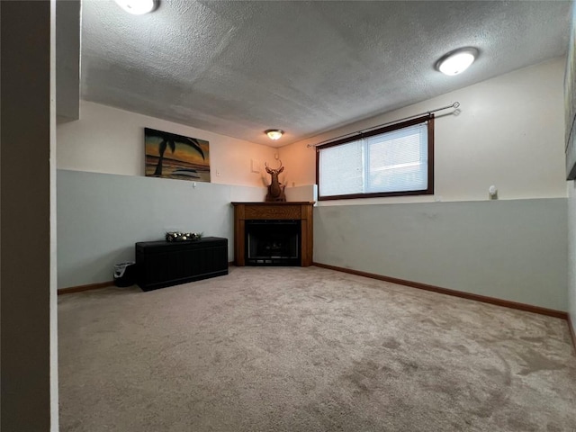 unfurnished living room with carpet flooring and a textured ceiling