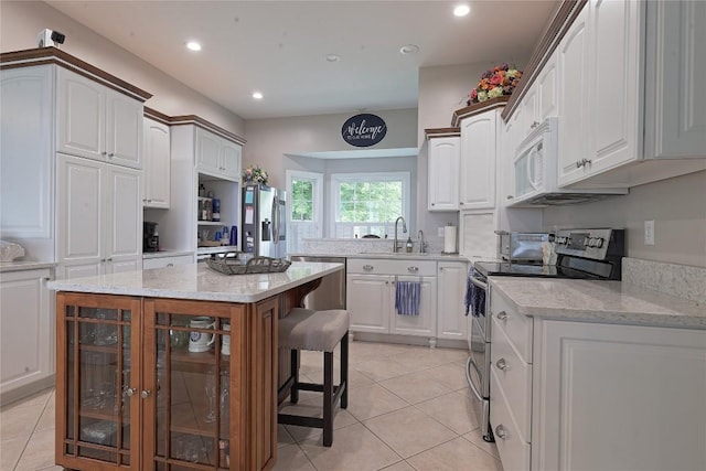 8280 Shore Dr, Fairview, PA 16415 - kitchen featuring appliances with stainless steel finishes, wine cooler, light tile patterned floors, white cabinetry, and recessed lighting