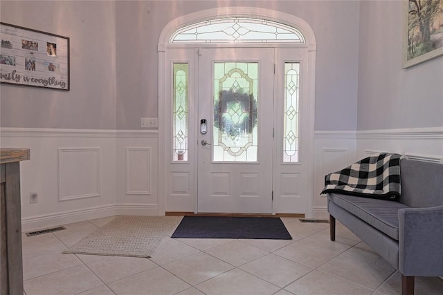 8280 Shore Dr, Fairview, PA 16415 - entryway with wainscoting, light tile patterned floors, and a decorative wall