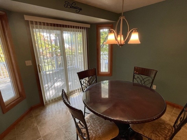 dining room with light tile patterned floors and a notable chandelier