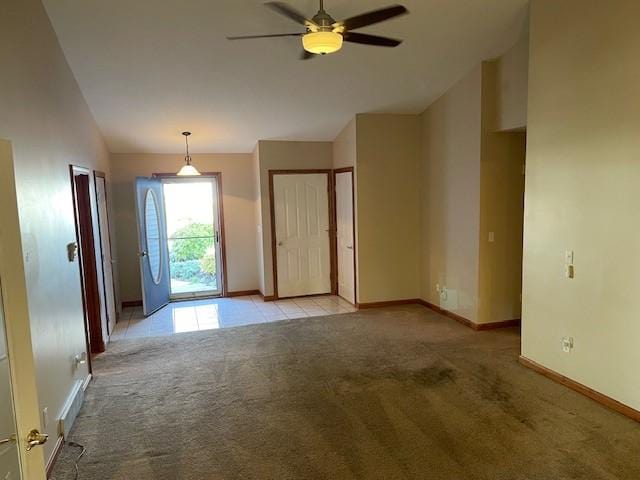 carpeted empty room with ceiling fan and lofted ceiling