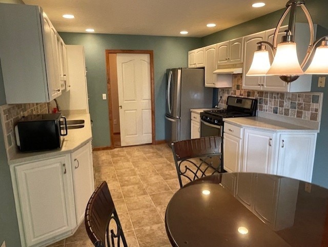 kitchen featuring backsplash, hanging light fixtures, white cabinets, and stainless steel appliances