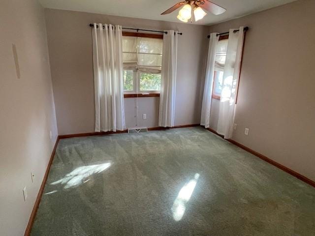 spare room with ceiling fan and carpet