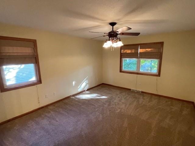 empty room featuring carpet flooring and ceiling fan