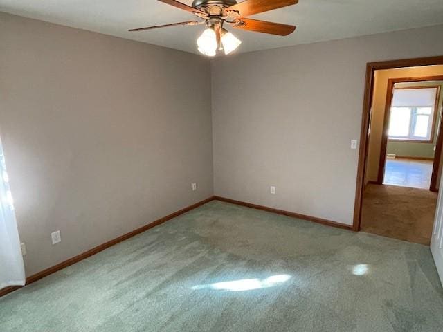 carpeted empty room featuring ceiling fan