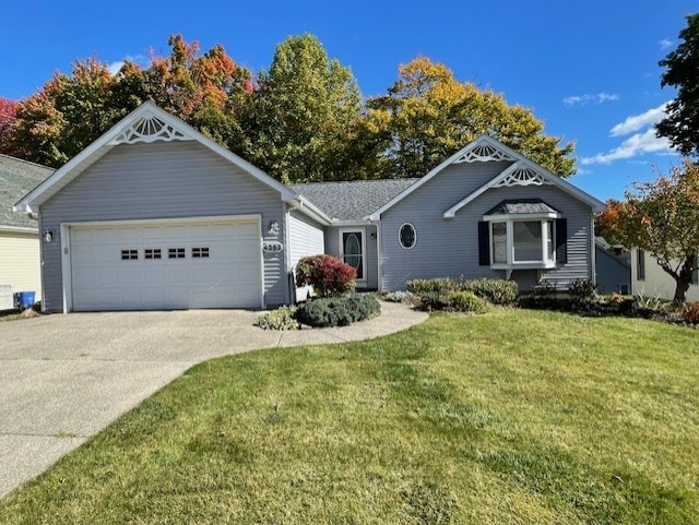 view of front of house with a front yard and a garage