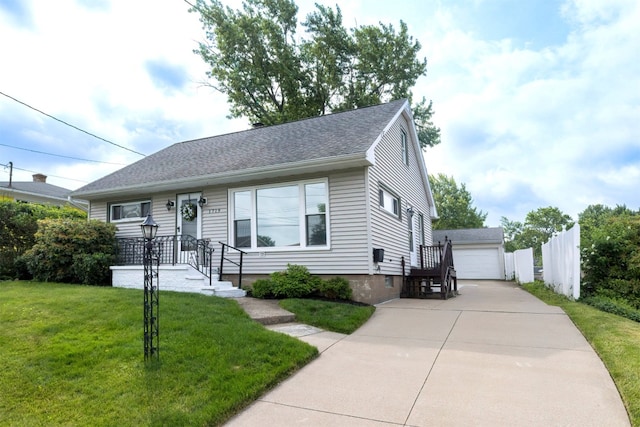 1719 W 41st St, Erie, PA 16509 - view of front facade featuring an outdoor structure, a front lawn, a detached garage, and roof with shingles