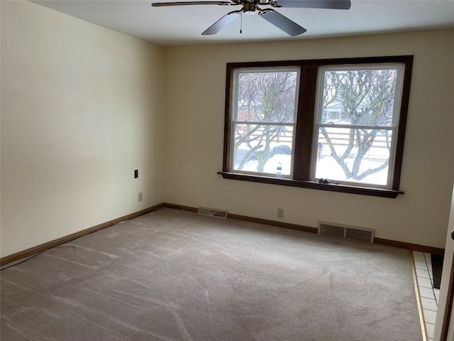 empty room featuring carpet floors and ceiling fan