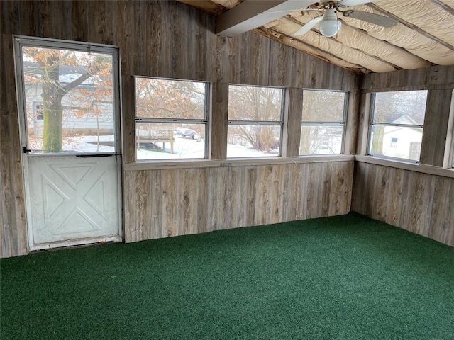 unfurnished sunroom with ceiling fan and lofted ceiling with beams