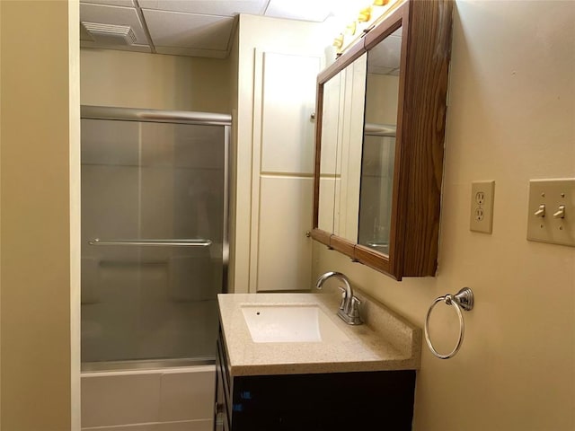 bathroom with a shower with door and vanity