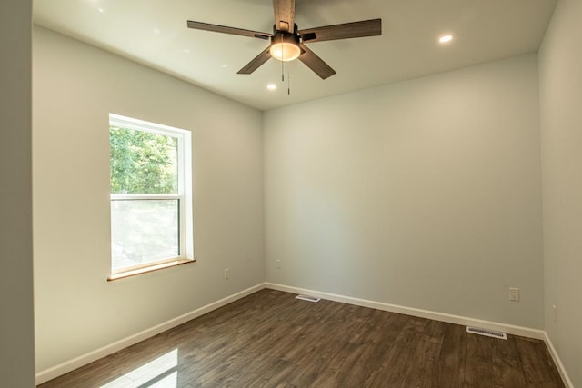 unfurnished room featuring ceiling fan and dark wood-type flooring