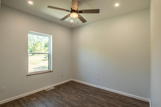 spare room with ceiling fan and dark wood-type flooring