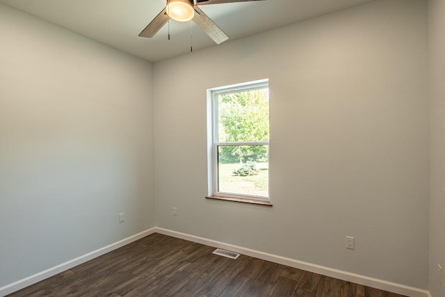 empty room featuring ceiling fan and dark hardwood / wood-style flooring