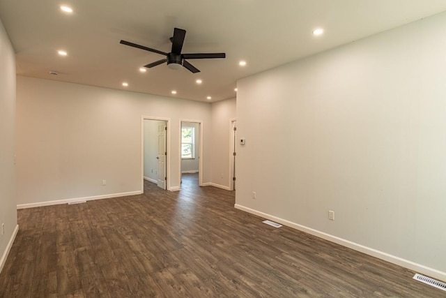 spare room with ceiling fan and dark wood-type flooring