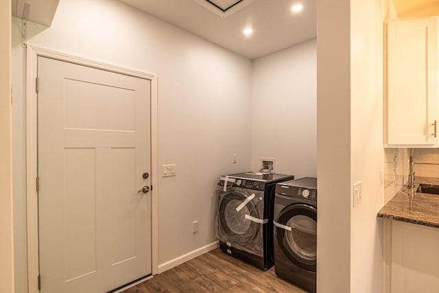 washroom with washer and dryer and dark hardwood / wood-style floors