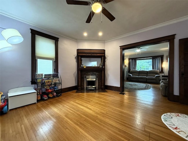 566 Walnut St, Meadville, PA 16335 - living room featuring ceiling fan, a fireplace with flush hearth, hardwood / wood-style flooring, and ornamental molding