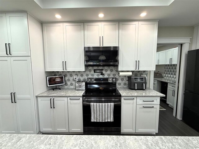 566 Walnut St, Meadville, PA 16335 - kitchen with black appliances, backsplash, white cabinets, light stone counters, and recessed lighting