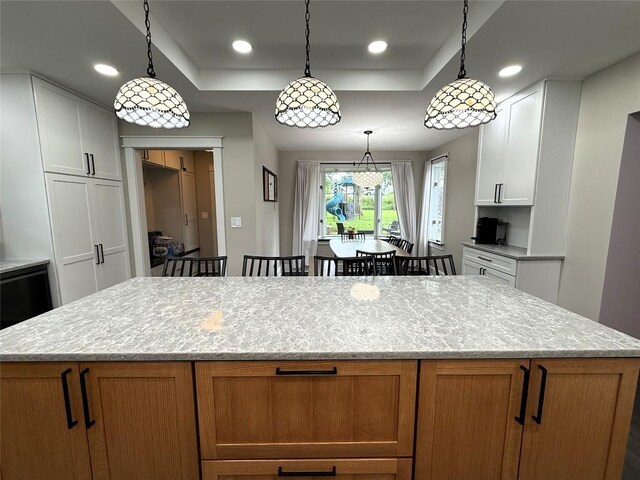 566 Walnut St, Meadville, PA 16335 - kitchen featuring a tray ceiling, a kitchen island, light stone counters, white cabinets, and recessed lighting