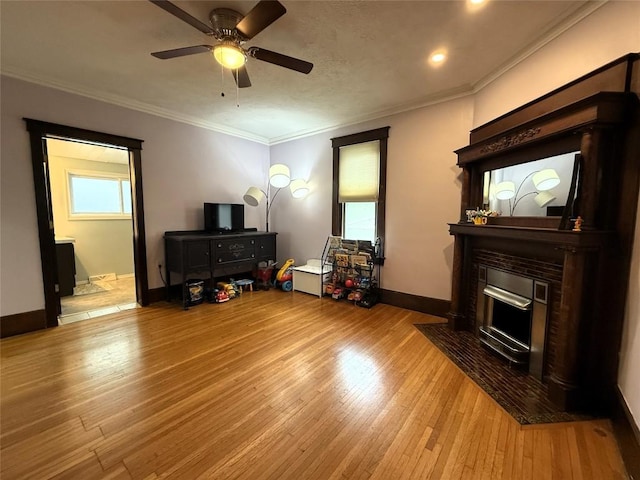 566 Walnut St, Meadville, PA 16335 - living room featuring a fireplace with flush hearth, wood finished floors, a ceiling fan, crown molding, and recessed lighting