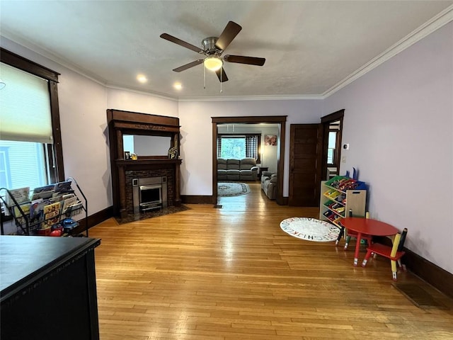 566 Walnut St, Meadville, PA 16335 - living area featuring a ceiling fan, a fireplace with flush hearth, light wood-style floors, and ornamental molding