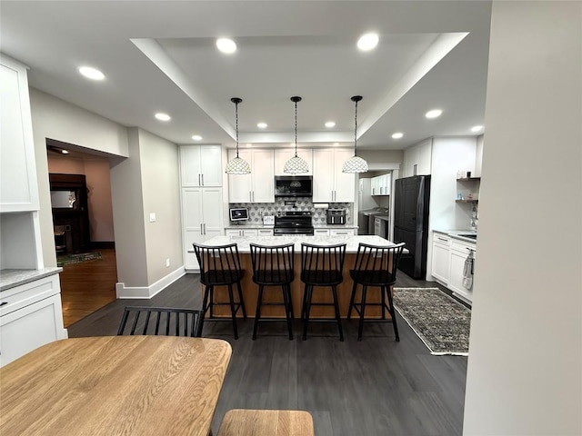 566 Walnut St, Meadville, PA 16335 - kitchen featuring black appliances, recessed lighting, dark wood finished floors, decorative backsplash, and white cabinets