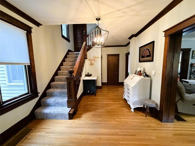 566 Walnut St, Meadville, PA 16335 - stairway featuring a chandelier, wood finished floors, and ornamental molding
