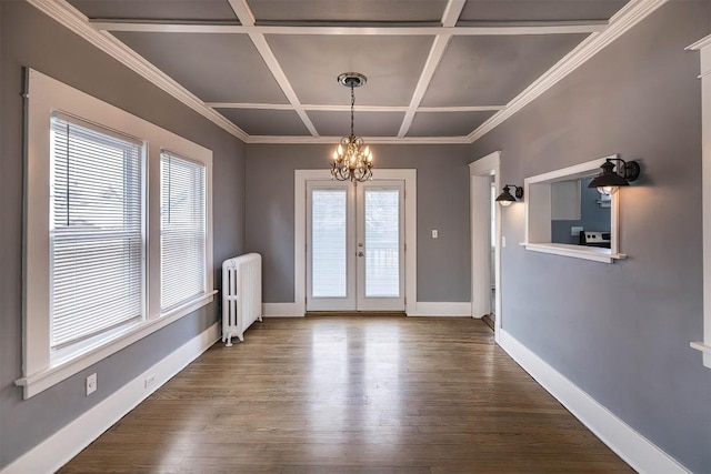 interior space with coffered ceiling, radiator heating unit, french doors, and plenty of natural light