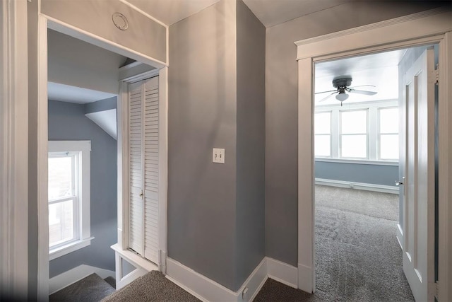 hallway featuring carpet floors and vaulted ceiling