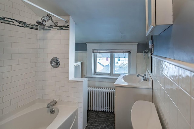 full bathroom with tiled shower / bath, radiator heating unit, vanity, toilet, and tile patterned floors