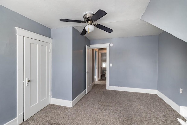 interior space with carpet floors and ceiling fan