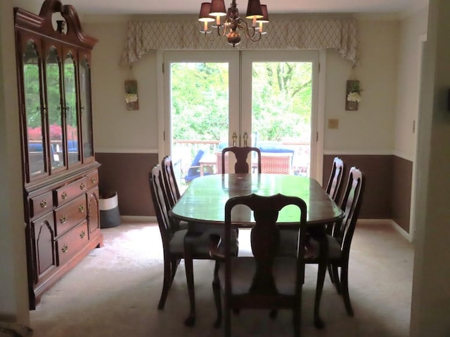12930 Park Lane Dr, Meadville, PA 16335 - dining area with light carpet, a chandelier, french doors, and baseboards