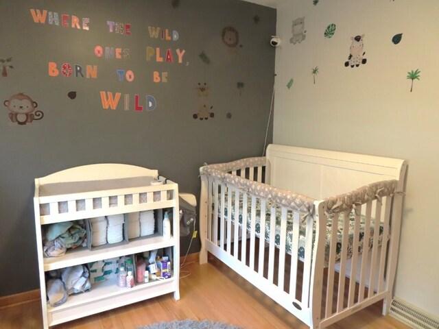 12930 Park Lane Dr, Meadville, PA 16335 - bedroom featuring wood finished floors, a crib, and baseboards