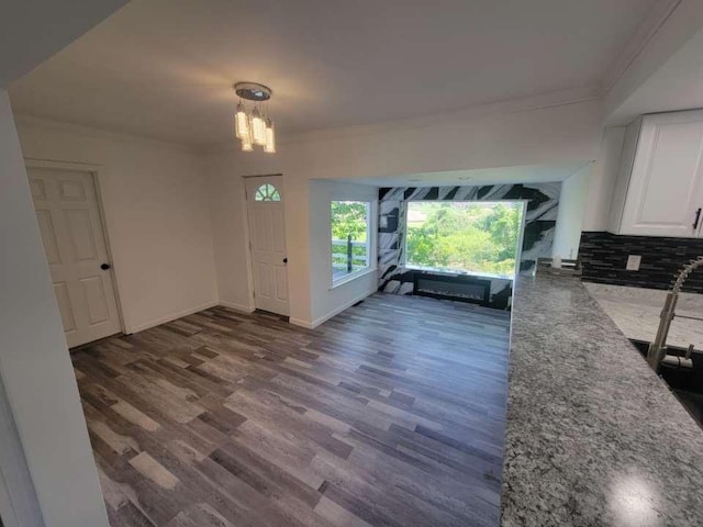 interior space featuring dark hardwood / wood-style flooring and an inviting chandelier