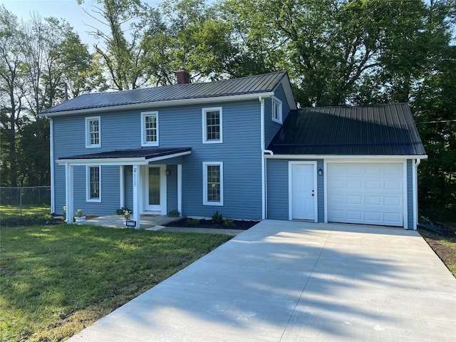 view of front of property featuring a front yard and a garage