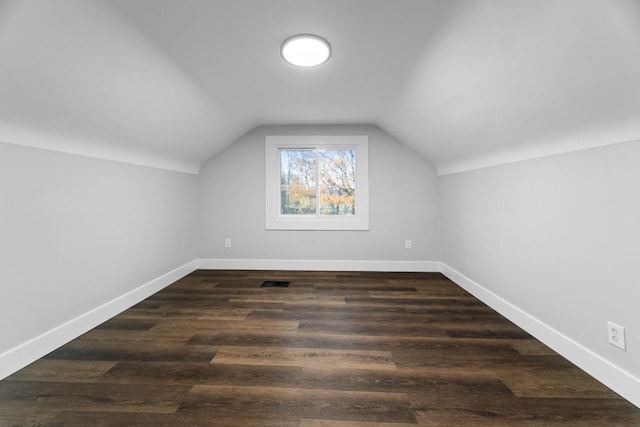 bonus room featuring dark hardwood / wood-style flooring and vaulted ceiling