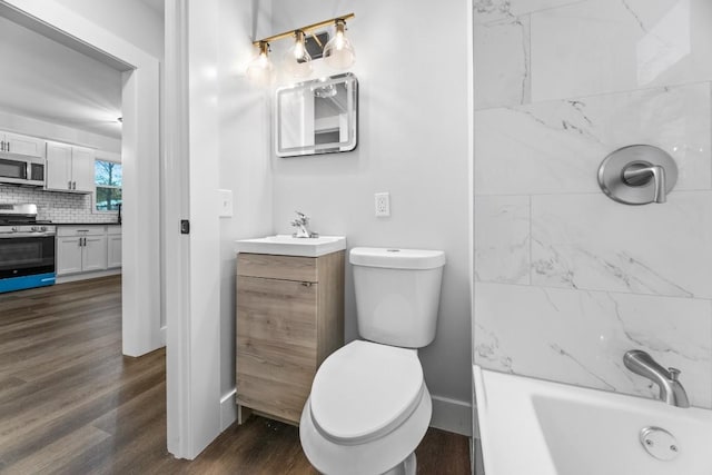 bathroom with decorative backsplash, vanity, hardwood / wood-style flooring, and toilet