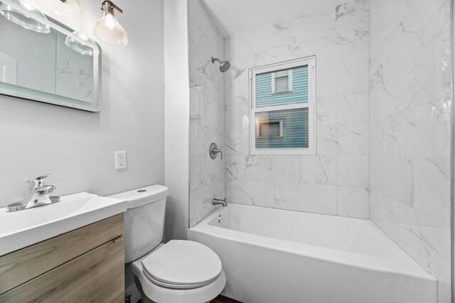 full bathroom with tiled shower / bath combo, toilet, and vanity