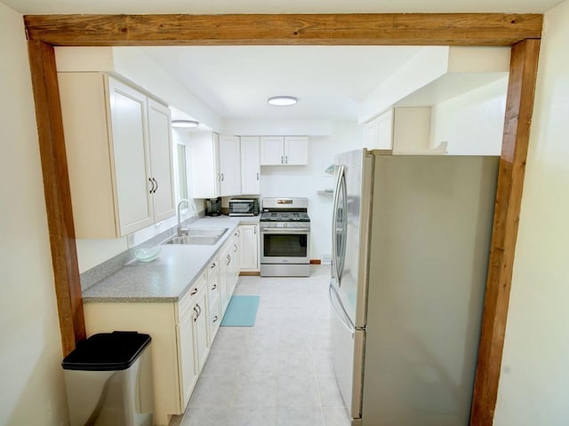 6620 W Ridge Rd, Fairview, PA 16415 - kitchen with stainless steel appliances, a sink, light countertops, and white cabinets