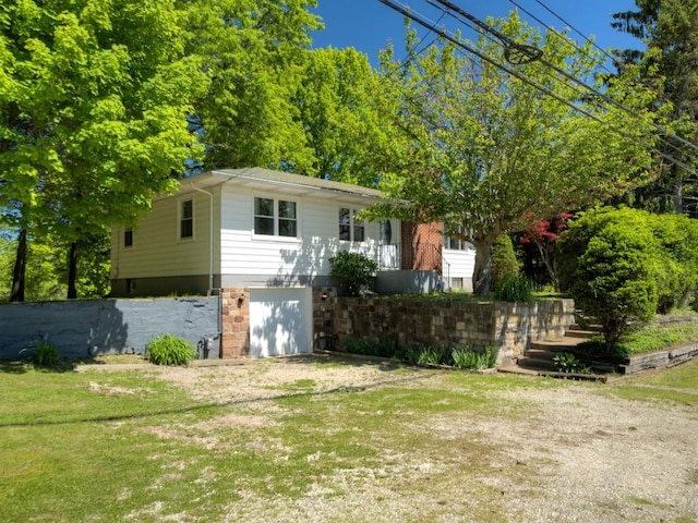 6620 W Ridge Rd, Fairview, PA 16415 - view of front facade with a garage, driveway, and a front lawn
