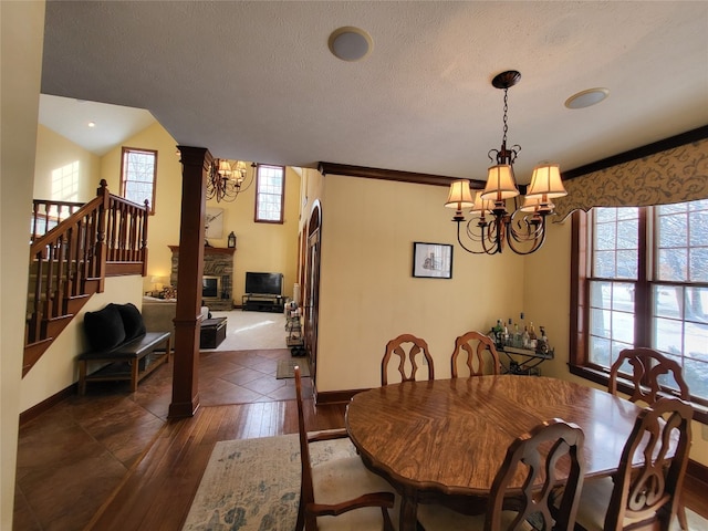 dining space with baseboards, a chandelier, dark wood finished floors, stairs, and a textured ceiling