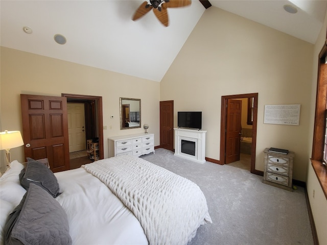 bedroom featuring baseboards, light carpet, ensuite bath, high vaulted ceiling, and a ceiling fan