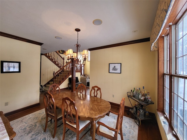 dining space featuring stairs, wood finished floors, and ornamental molding