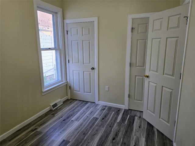 922 E 9th St, Erie, PA 16503 - unfurnished bedroom with dark wood-style flooring and multiple windows