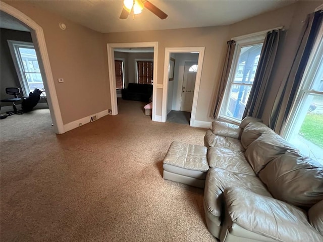 living room with ceiling fan and carpet floors