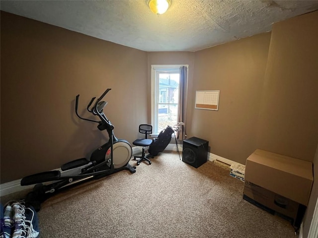 workout area with carpet flooring and a textured ceiling