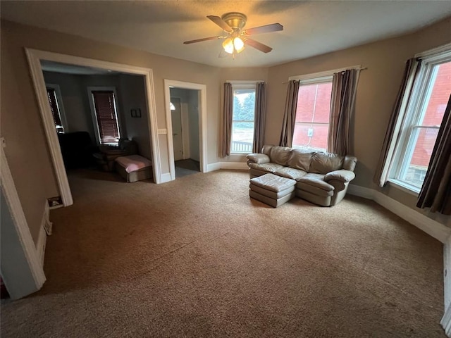 unfurnished living room with carpet, ceiling fan, and a healthy amount of sunlight